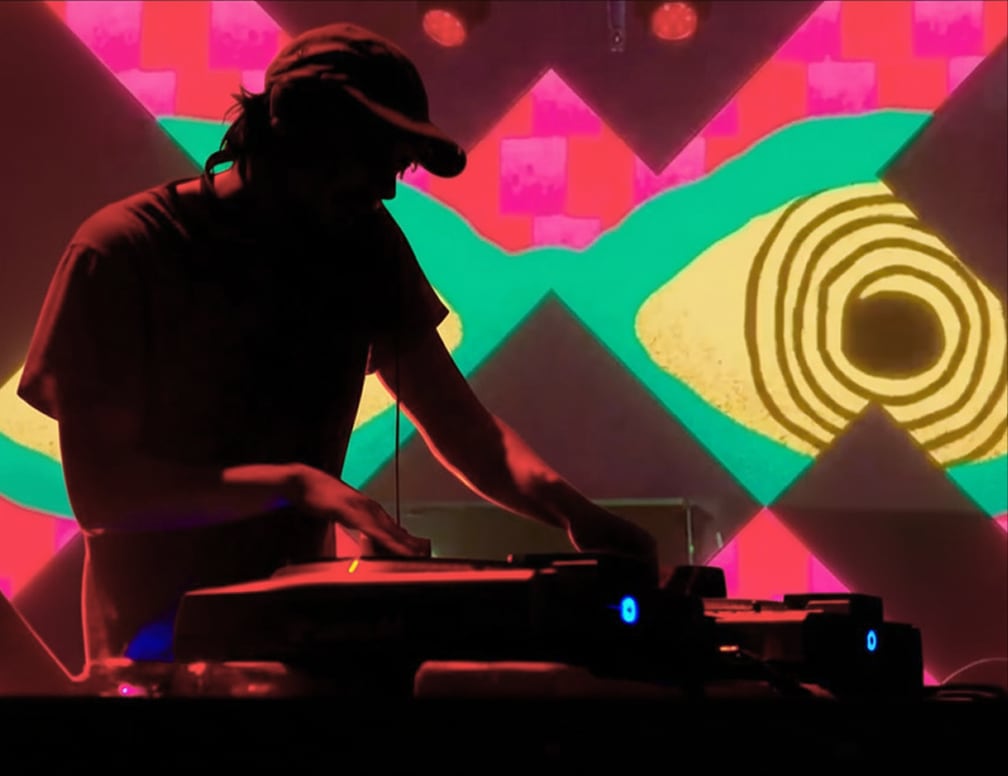 DJ on stage — neon target lights